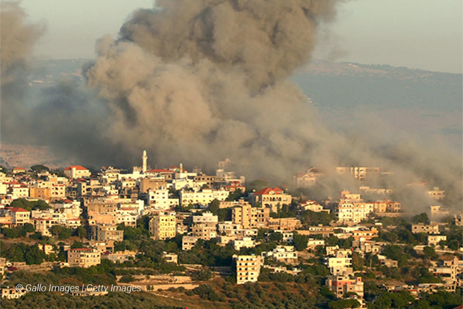 A long shot of smoke rising in Hezbollah, Lebanon after aerial strikes by Israel
